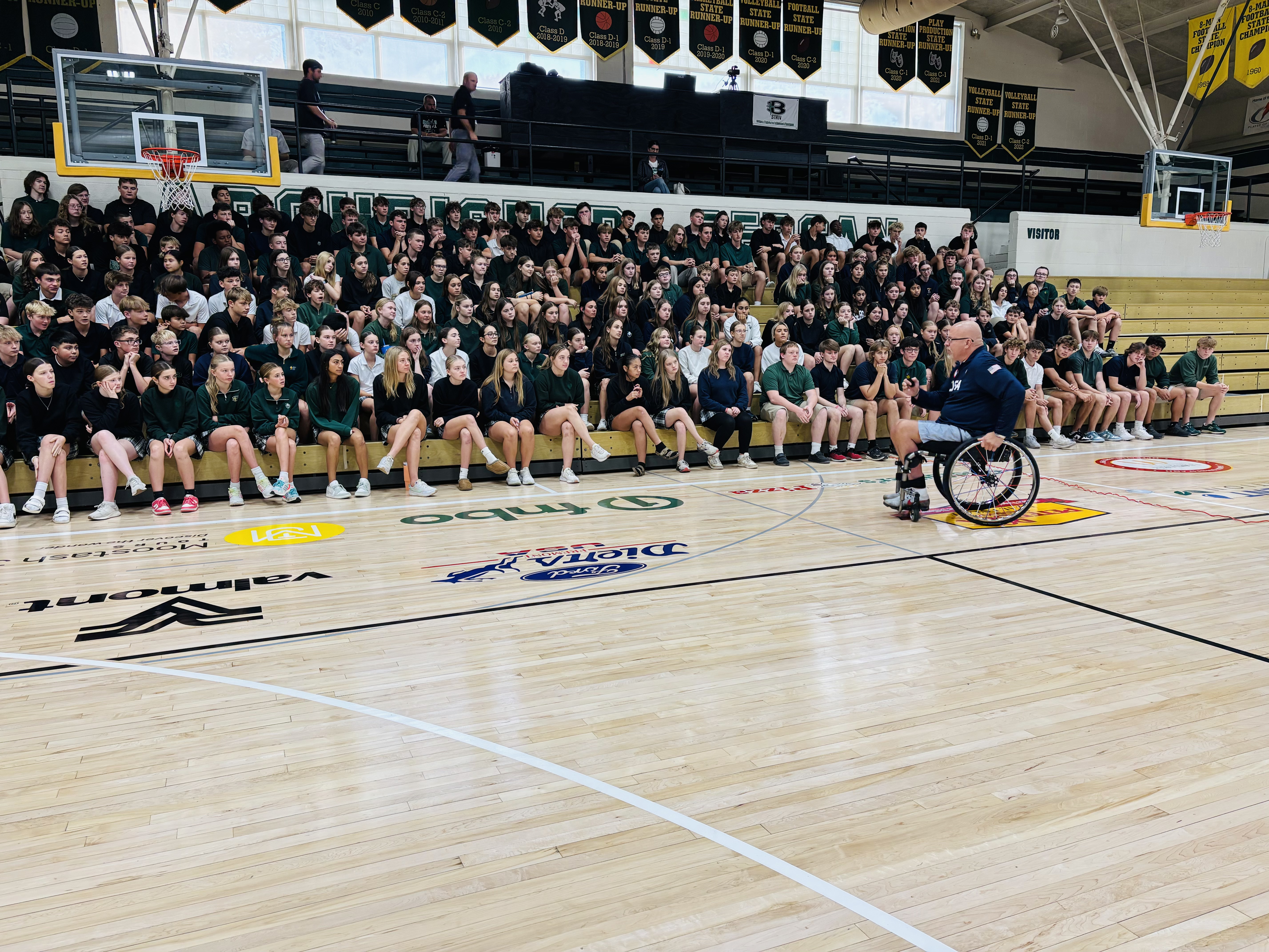Steve Emt speaking to a student assembly